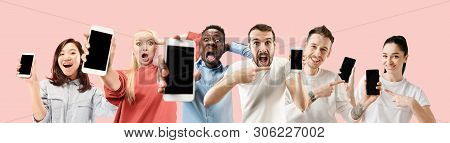 Portrait Of People Showing Mobile Phones Isolated Over Coral Background. Male And Female Models Usin
