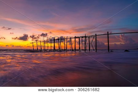 The Old Wooden Bridge And Sea Wave On The Beach At Sunset Sky Background At Khao Pilai, Phangnga, Th