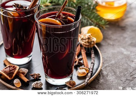 Hot Mulled Wine With Spices, Apple And Orange On Chrictmas Background. Copy Space.