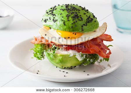 keto paleo diet avocado breakfast burger with bacon, egg, tomato