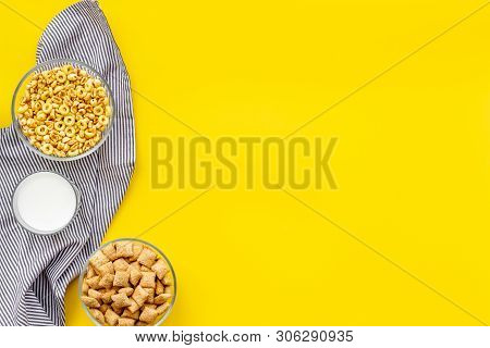 Cereals, Oatflakes And Cornflakes With Milk And Towel For Healthy Breakfast On Yellow Background Top