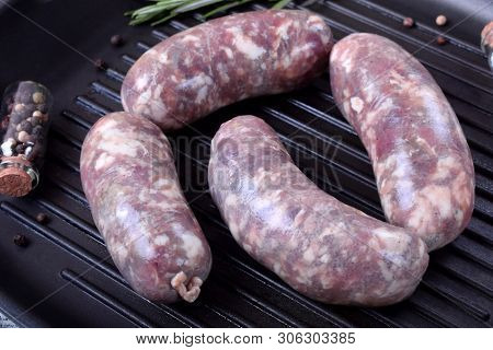 Raw Meat Sausages In A Natural Shell In A Griddle Pan Prepared For Cooking