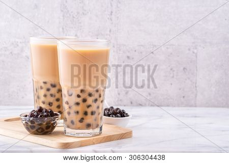 Popular Taiwan Drink - Bubble Milk Tea With Tapioca Pearl Ball In Drinking Glass On Marble White Tab