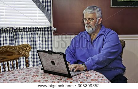 Senior Citizen Happy Using A Computer And Technology To Do Daily Activities