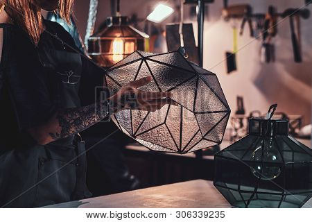 Talanted Young Designer With Tattoo On Her Hand Is Prepearing New Lamp, She Is Holdind It In Hands.