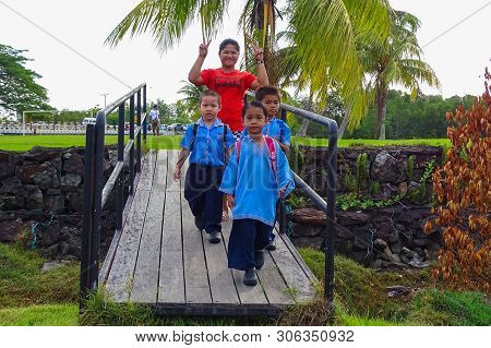 Labuan,malaysia-feb 2,2019:mother And Kids Going To School With Schoolbag In Patau Patau Water Villa