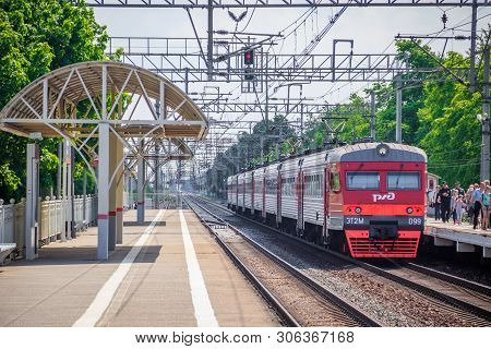 People Got Off The Train. . The Train Has Arrived. People Walk On The Platform. Russia, Leningrad Re