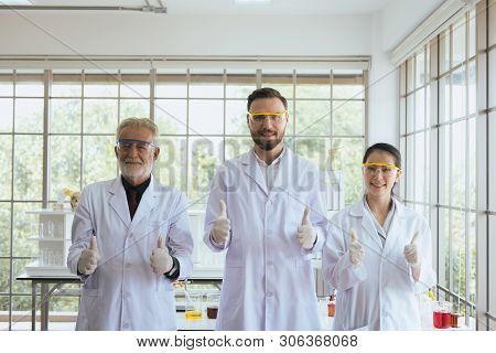 Group Of Scientists People Standing And Showing Thumb Up Together In Laboratory,successful Teamwork 