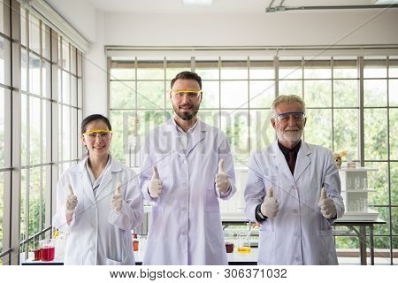 Group Of Scientists People Standing And Showing Thumb Up Together In Laboratory,successful Teamwork 