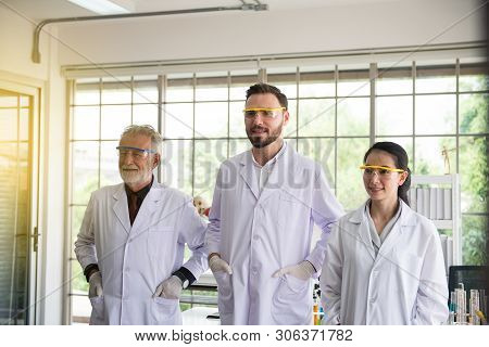Group Of Scientists People Standing Together In Laboratory,successful Teamwork And Reserch Working