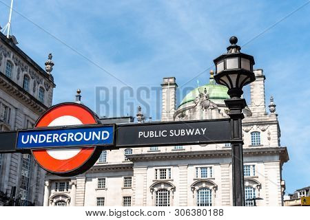 London, Uk - May 15, 2019: Low Angle View Of Underground Sign In Picadilly Circus Against Sky A Sunn