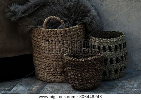 Hree Wicker Straw Baskets And A Fur Coat Are Left In The Courtyard Of The House On A Stone Floor Nea
