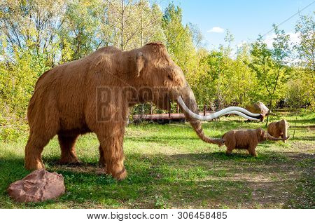 Russia, Moscow - September 29, 2018: A Huge Life-sized Mammoth With Two Children. Ice Age