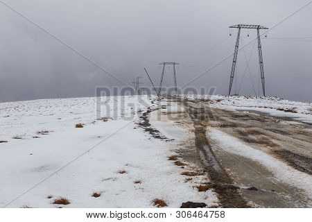 High Voltage Poles On A Snow-covered Hill, Mutnowskaya Power Station, Eastern Mountains. Jelizevo Di