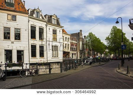 Gouda, Holland, Netherlands, April 23, 2019, Bicycles And Parked Near A Bridge Along A Street, Canal
