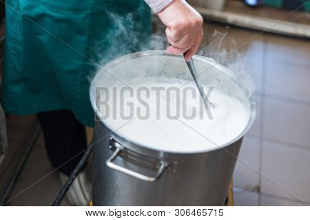 A Woman Cooks Milk In A Vat And Makes Cottage Cheese And Cheese At Home. Production Of Cheese On The