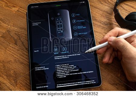 Paris, France - Jun 6, 2019: Man Reading On Apple Ipad Pro Tablet About Powerful Professional Workst