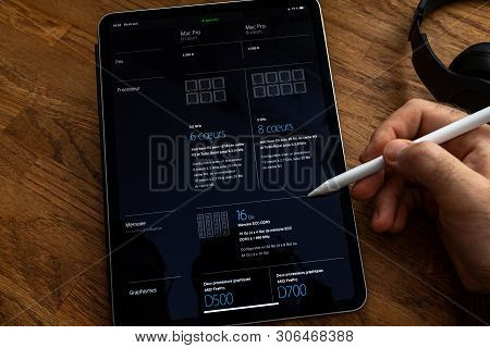 Paris, France - Jun 6, 2019: Man Reading On Apple Ipad Pro Tablet About Powerful Professional Workst