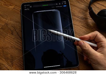 Paris, France - Jun 6, 2019: Man Reading On Apple Ipad Pro Tablet About Powerful Professional Workst
