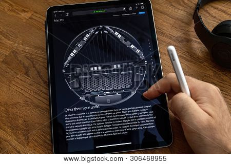 Paris, France - Jun 6, 2019: Man Reading On Apple Ipad Pro Tablet About Powerful Professional Workst