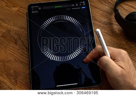 Paris, France - Jun 6, 2019: Man Reading On Apple Ipad Pro Tablet About Powerful Professional Workst