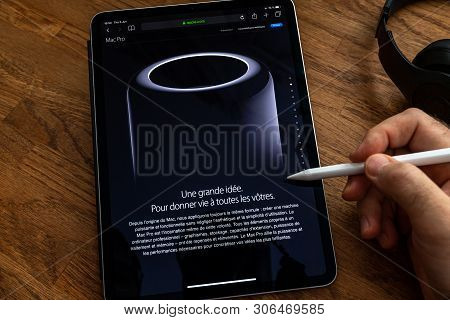 Paris, France - Jun 6, 2019: Man Reading On Apple Ipad Pro Tablet About Powerful Professional Workst