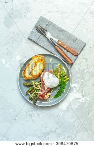 Green Asparagus And Boiled Poached Egg With Hamon (jamon) And Chopped Parmigiano (parmesan) On A Lig