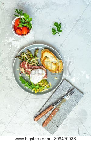 Green Asparagus And Boiled Poached Egg With Hamon (jamon) And Chopped Parmigiano (parmesan) On A Lig