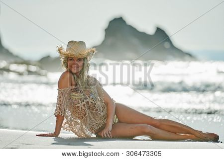 young woman relaxing on the beach in summer day