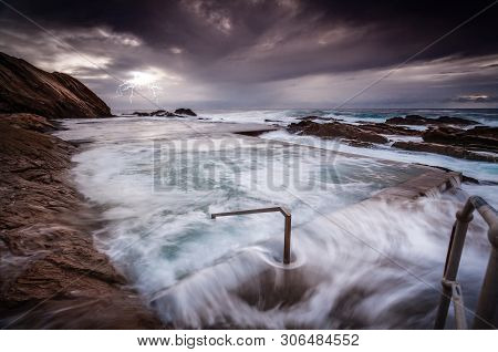 Rough Seas After A Storm Had Large Waves Crashing Over And Into The Rock Pool And Swift Overflows Ru