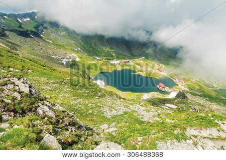 Lake Balea In Dramatic Weather. Beautiful Destination In Fagaras Mountain Of Romania. View Through C