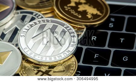 Physical Metal Silver Litecoin Currency On Notebook Computer Keyboard Ltc