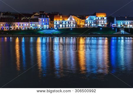 Traetskae Pradmestse Or Trinity Suburb On Svisloch River Bank At Night. Historical Center Of Minsk. 