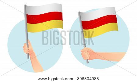 South Ossetia Flag In Hand. Patriotic Background. National Flag Of South Ossetia  Illustration