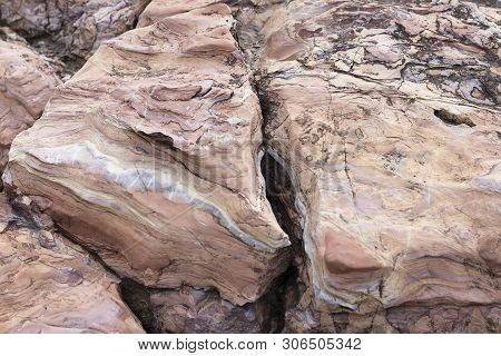 The Rock Is Red With A Rift. The Crack In The Stone, A Piece Of A Broken Stone Brown Color. Red Ston