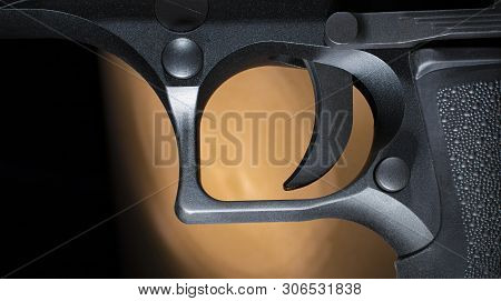 Trigger On A Semi Auto Handgun With A Dark Background