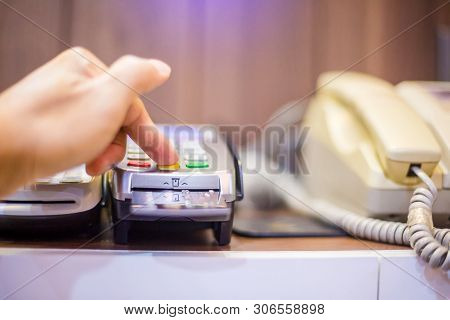 Hand Put Credit Card In Slot And Press The Button Of Credit Card Reader.