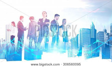Members Of Confident And Diverse Business Team Working With Documents And Gadgets Over Cityscape Bac