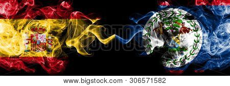Spain Vs Belize, Belizean Smoky Mystic Flags Placed Side By Side. Thick Colored Silky Smokes Flag Of