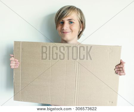 Boy Showing Blank Signboard with Empty Copyspace