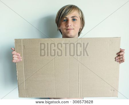 Boy Showing Blank Signboard with Empty Copyspace