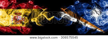 Spain Vs Marshall Islands Smoky Mystic Flags Placed Side By Side. Thick Colored Silky Smokes Flag Of