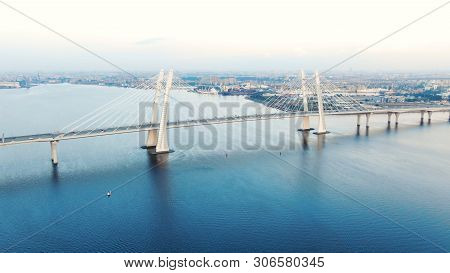 Cable-stayed Bridge And Cars Speeding Against Cityscape