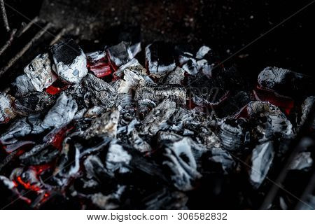 Bbq Grill Pit With Glowing And Flaming Hot Charcoal Briquettes, Food Background Or Texture, Burning 