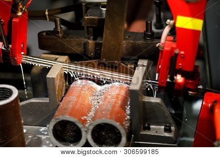 Automatic Band Saw Machine Cutting Metal Pipes With Coolant. Selective Focus.