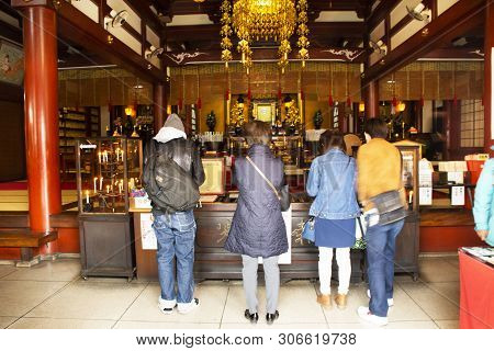 Japanese People And Foreigner Travelers Praying Buddha God And Angel Statue Inside Of Marishiten Tok