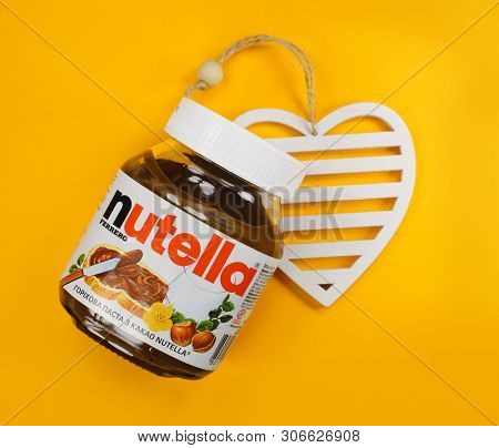 Kyiv, Ukraine - May 27, 2019: Nutella introduced to the market in 1964 by Italian company Ferrero. Nutella hazelnut on yellow background