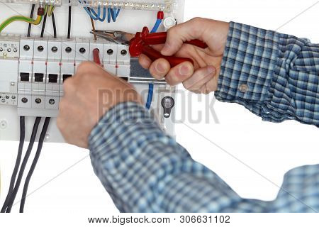 Electrician Is Repairing An Electrical Device With Tools