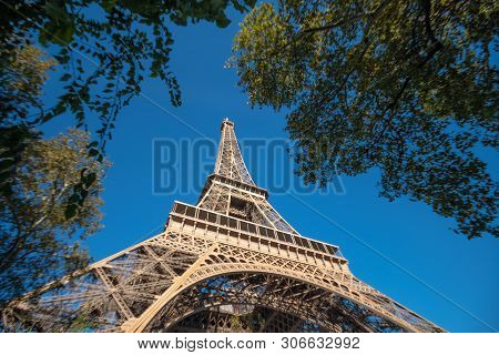 Eifel Tower Full Length Bottom Up Low Angle Shot From Tower Basement With Blue Sky Cloudy Background