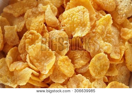 Close Up Of Cornflakes In A Bowl, A Breakfast Cereal Made By Toasting Flakes Of Corn Or Maize.